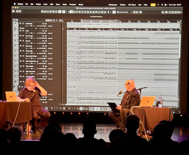 Inside the sessions — A look at the original multitrack session, tracing how the record was built layer by layer Ed Buller and an interviewer on stage in front of a large screen showing a Cubase multitrack of recordings